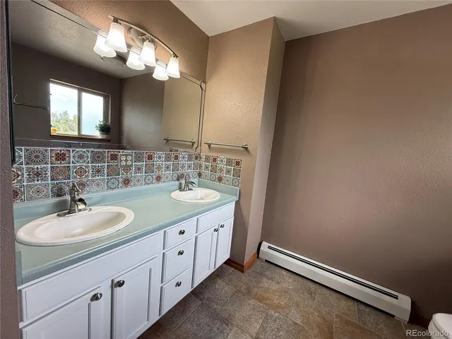 a bathroom with a double vanity sink and a mirror
