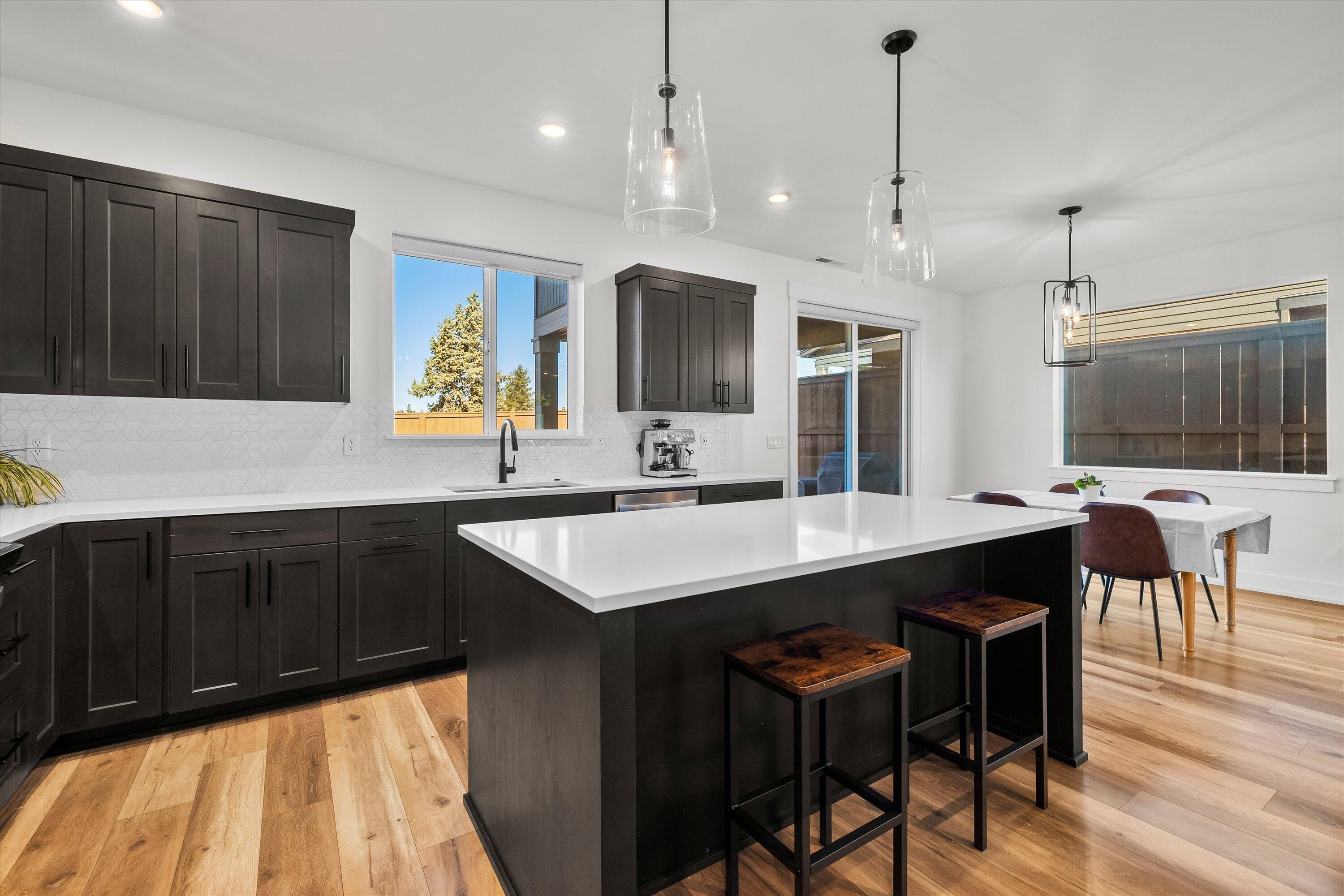 60903 Southeast Epic Place Bend, OR 97702 - Photo 15 of 48 a kitchen with a counter space a sink cabinets and wooden floor