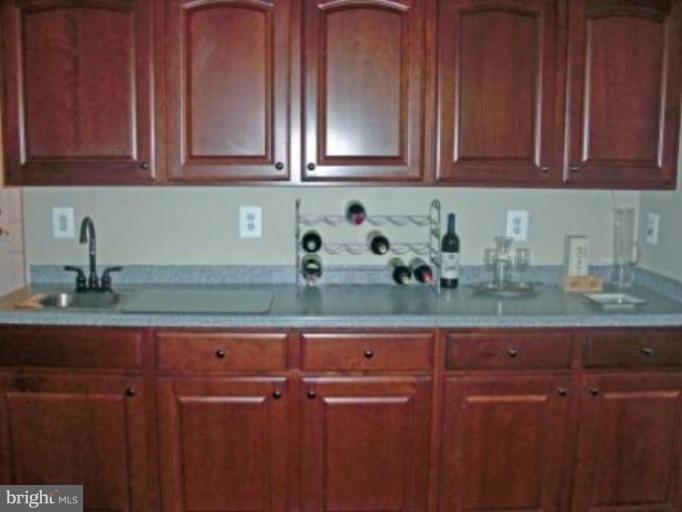 10275 Rutland Round Road, Unit 41 Columbia, MD 21044 - Photo 17 of 17 Wet Bar and Cherry Wood Cabinets in Basement