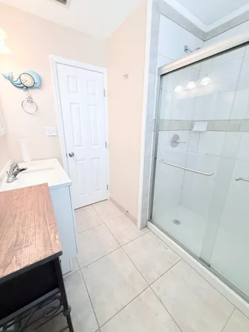 a bathroom with a glass shower door