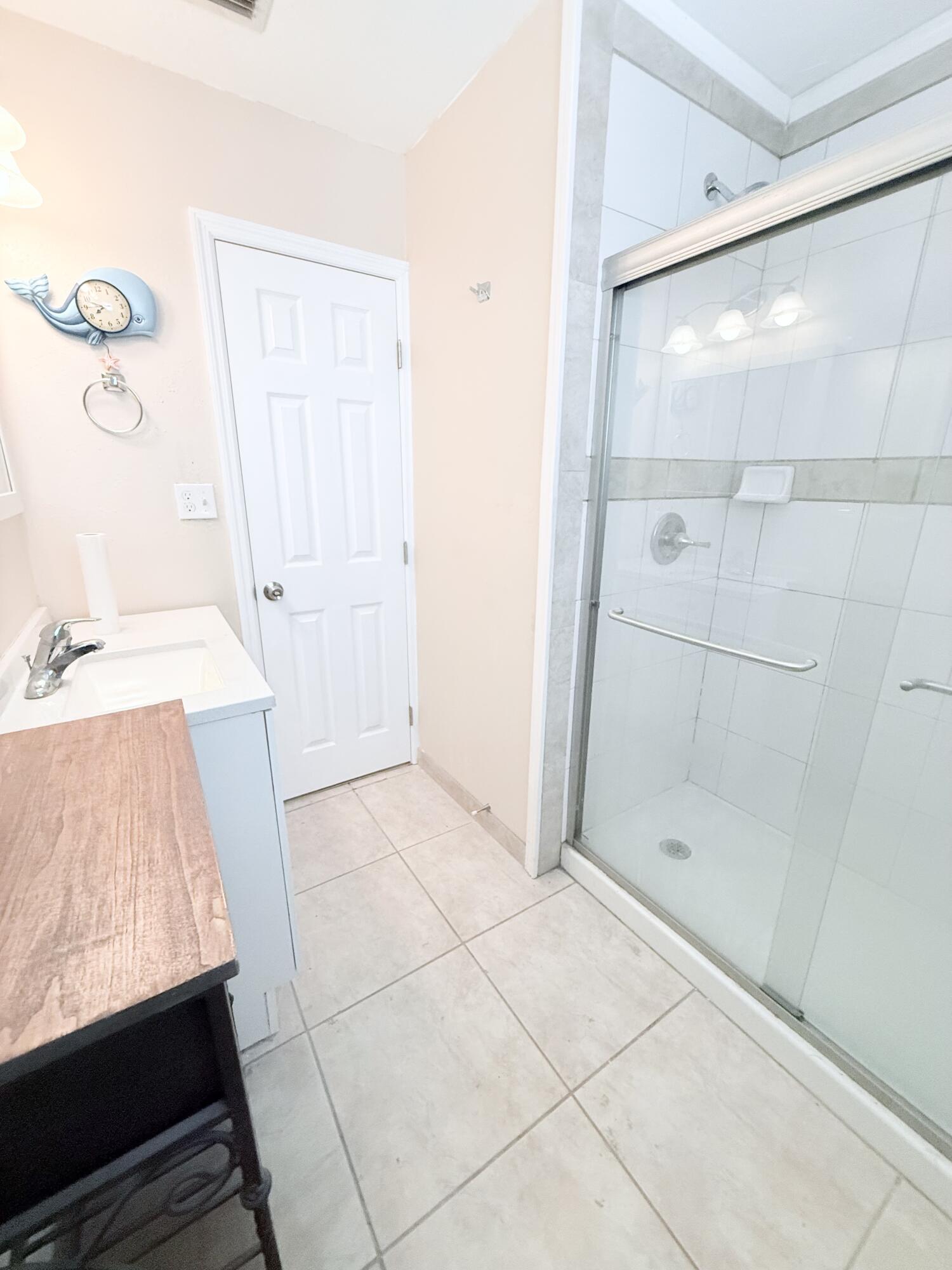 1025 Ash Circle Okeechobee, FL 34974 - Photo 16 of 26 a bathroom with a glass shower door