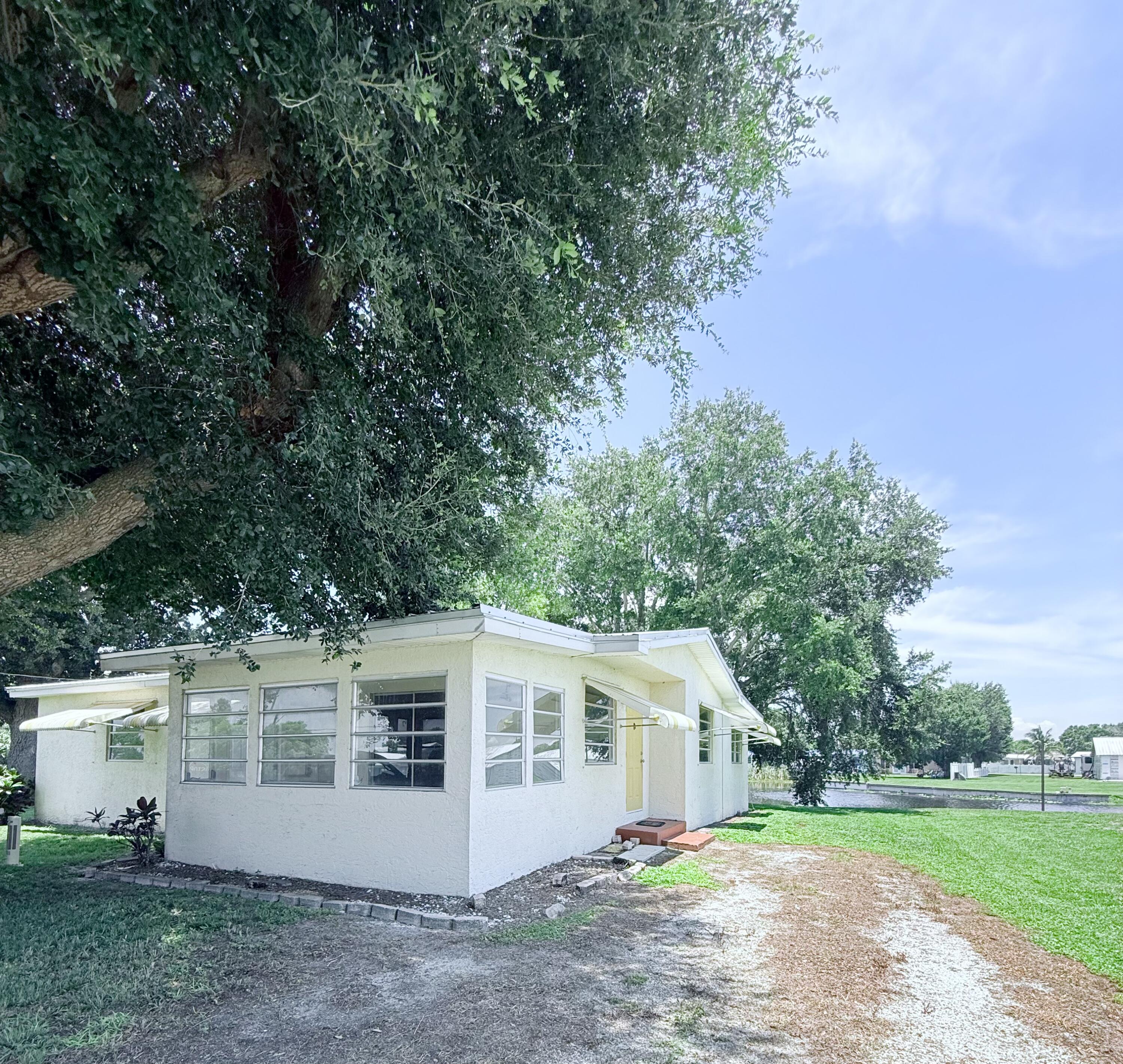 1025 Ash Circle Okeechobee, FL 34974 - Photo 2 of 26 a view of a house with yard and a tree