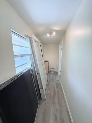 a view of entryway and hall with wooden floor