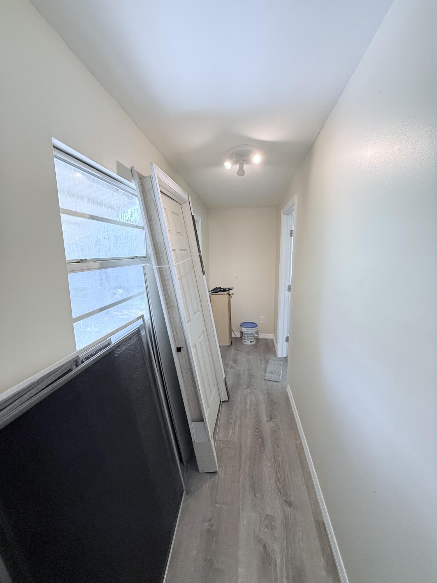 1025 Ash Circle Okeechobee, FL 34974 - Photo 22 of 26 a view of entryway and hall with wooden floor