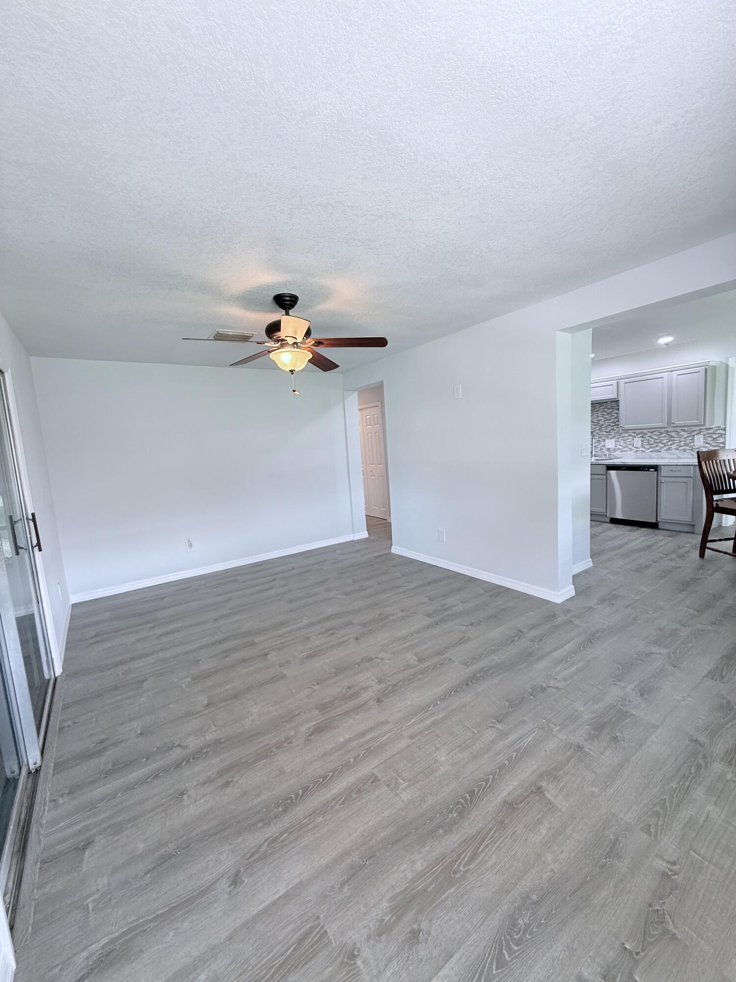 1025 Ash Circle Okeechobee, FL 34974 - Photo 5 of 26 a view of a livingroom with wooden floor
