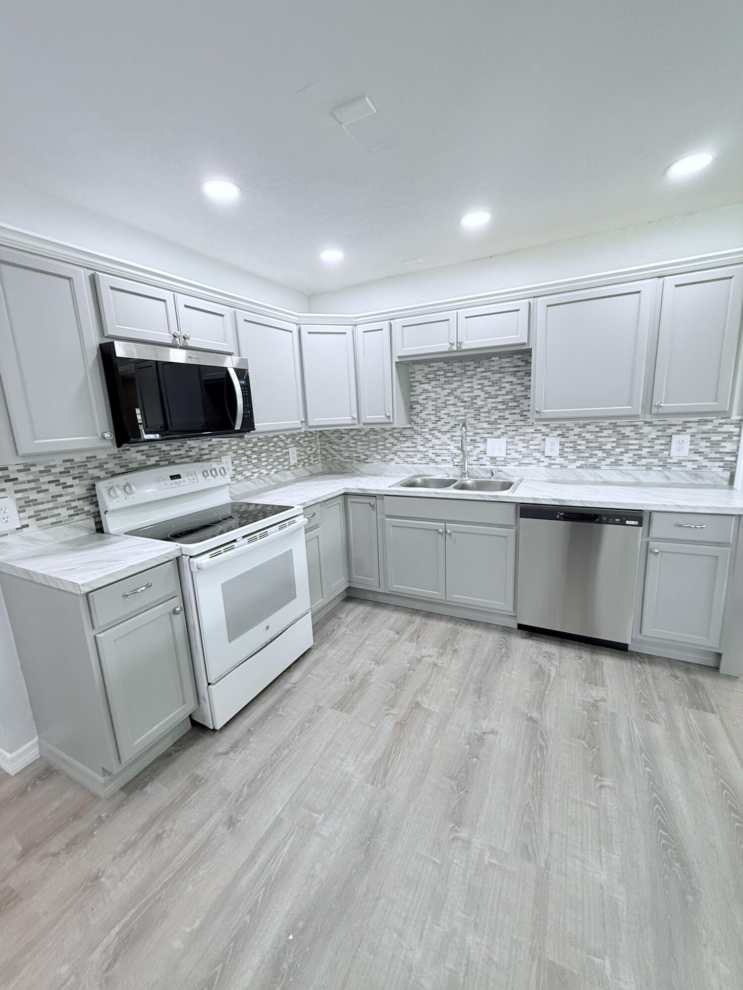 1025 Ash Circle Okeechobee, FL 34974 - Photo 9 of 26 a kitchen with granite countertop a sink and cabinets