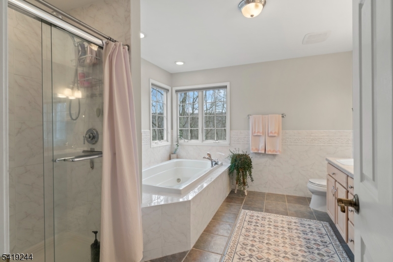 57 Paderewski Road Oak Ridge, NJ 07438 - Photo 15 of 42 a bathroom with a bathtub and a shower