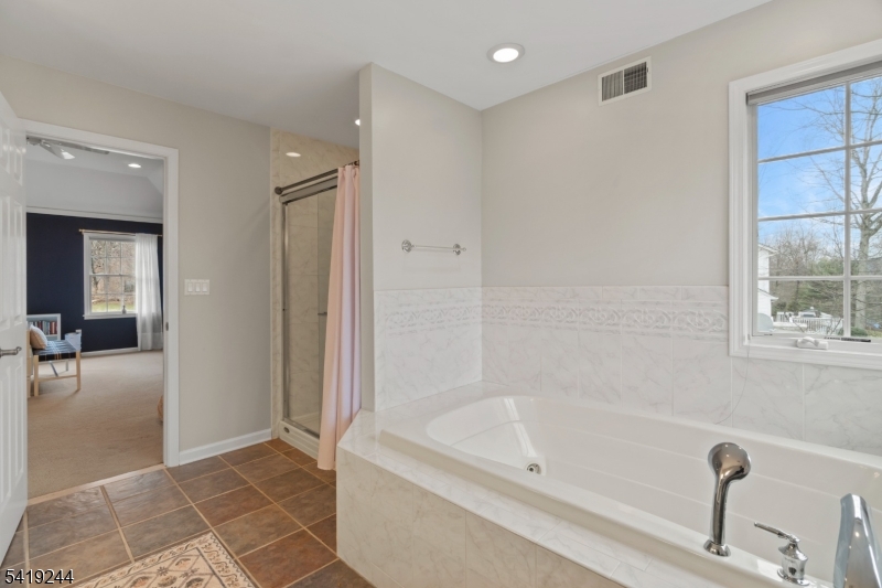 57 Paderewski Road Oak Ridge, NJ 07438 - Photo 16 of 42 a bathroom with a bathtub and shower