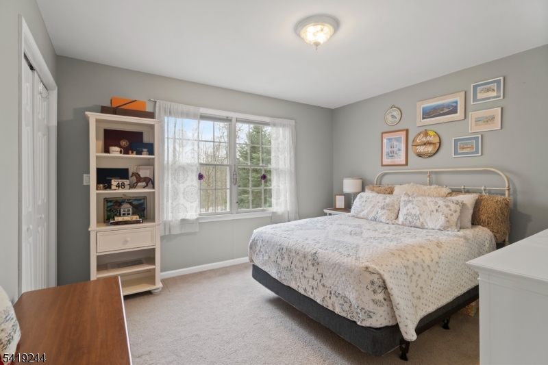 57 Paderewski Road Oak Ridge, NJ 07438 - Photo 20 of 42 a bedroom with a bed and a window