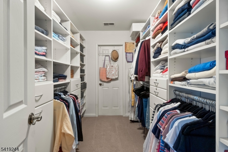 57 Paderewski Road Oak Ridge, NJ 07438 - Photo 21 of 42 a view of walk in closet with clothes and shoes