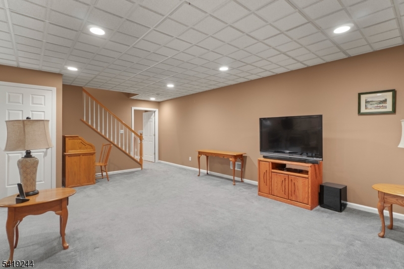 57 Paderewski Road Oak Ridge, NJ 07438 - Photo 25 of 42 an empty room with wooden floor and furniture