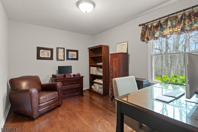 57 Paderewski Road Oak Ridge, NJ 07438 - Photo 30 of 42 a living room with furniture and a wooden floor