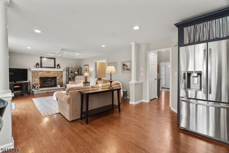 57 Paderewski Road Oak Ridge, NJ 07438 - Photo 32 of 42 a living room with furniture a fireplace and a flat screen tv