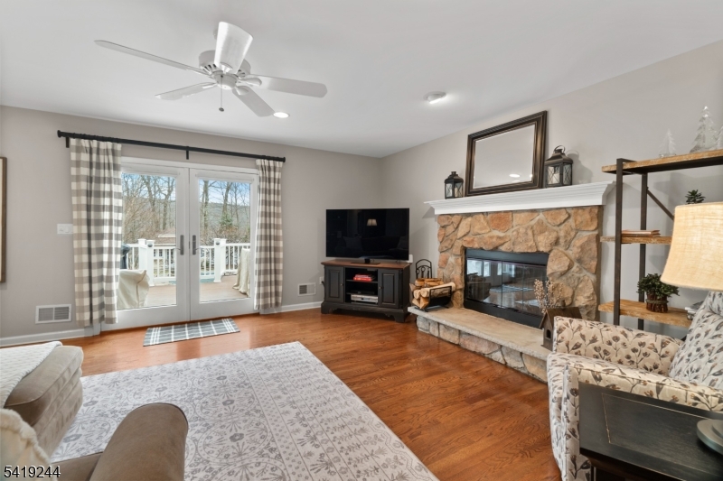 57 Paderewski Road Oak Ridge, NJ 07438 - Photo 36 of 42 a living room with furniture and a fireplace