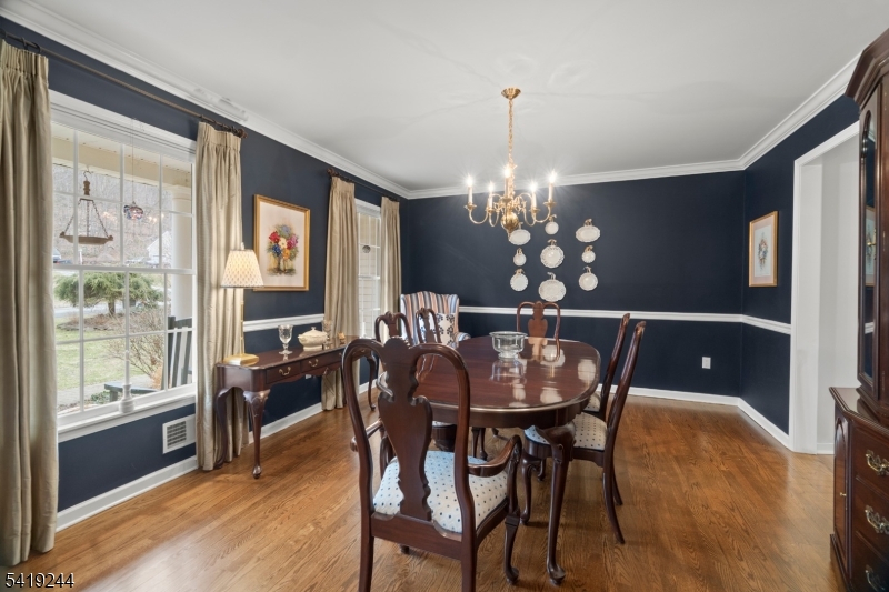 57 Paderewski Road Oak Ridge, NJ 07438 - Photo 39 of 42 a view of a dining room with furniture window and wooden floor