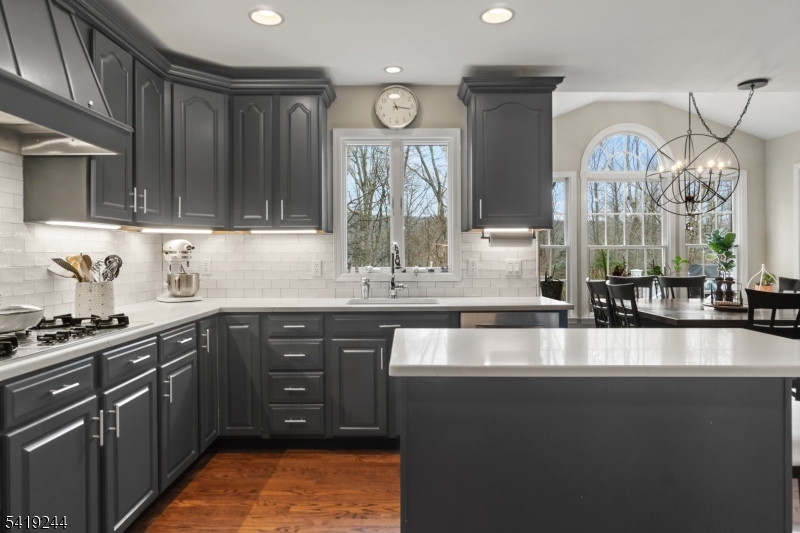 57 Paderewski Road Oak Ridge, NJ 07438 - Photo 8 of 42 a large kitchen with stainless steel appliances granite countertop a stove a sink dishwasher and cabinets with wooden floor