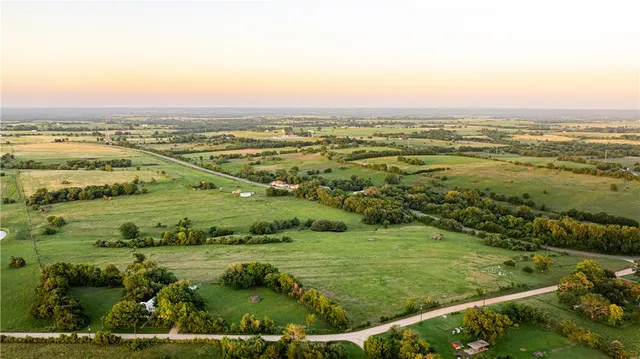 an aerial view of ocean with residential houses with outdoor space