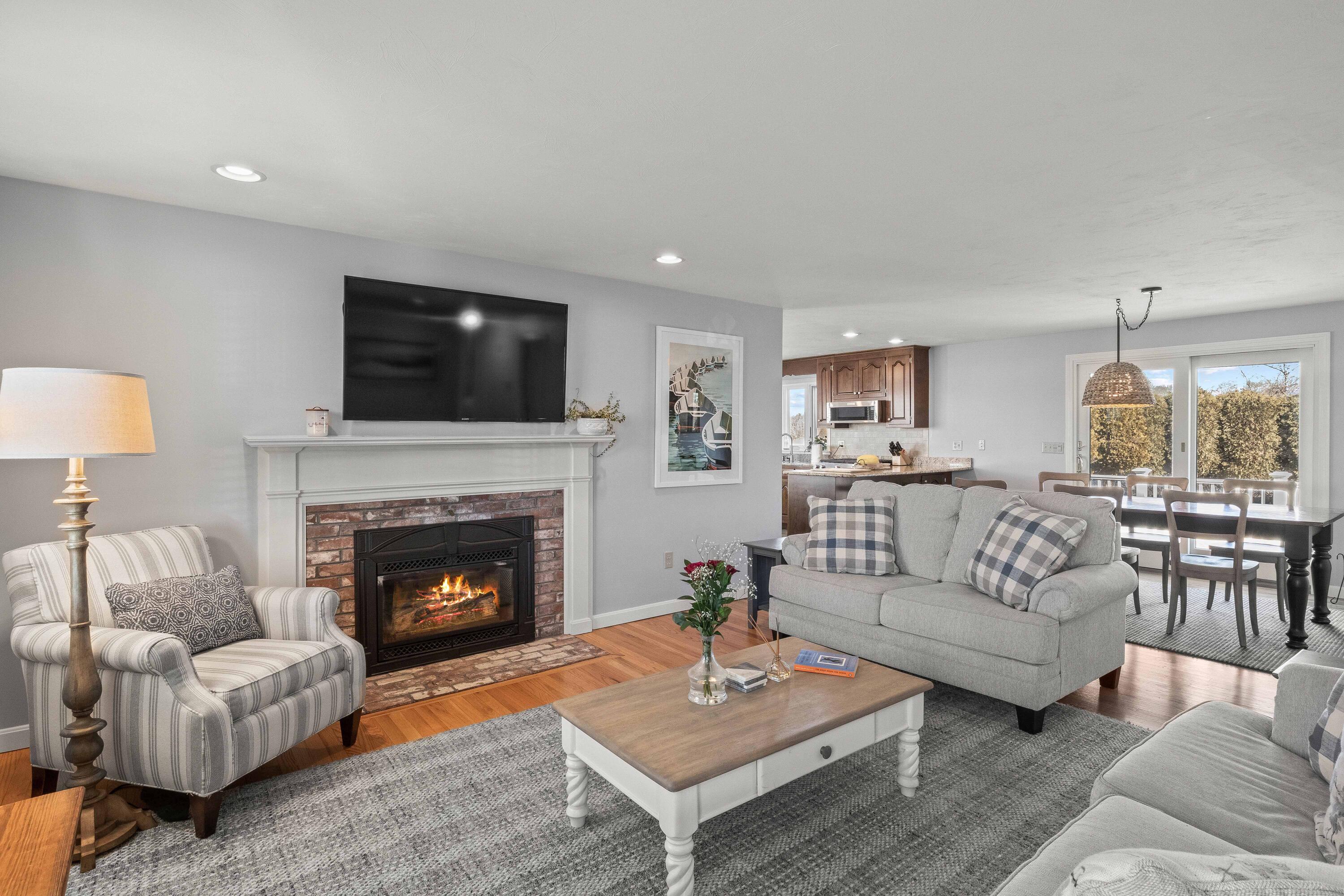 356 Lower County Road Harwich Port, MA 02646 - Photo 9 of 27 a living room with furniture a flat screen tv and a fireplace