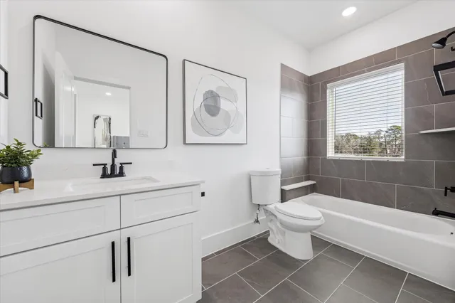 a bathroom with a sink a toilet and a bathtub