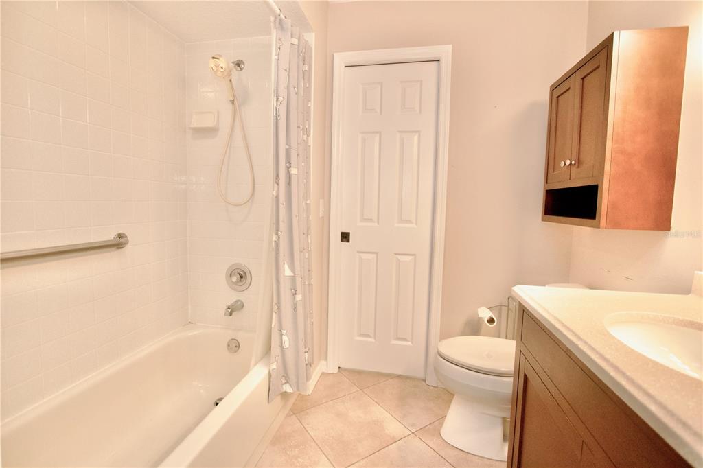 7842 Tenby Court New Port Richey, FL 34655 - Photo 9 of 27 a bathroom with a sink a toilet and shower