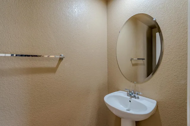 a bathroom with a sink and mirror