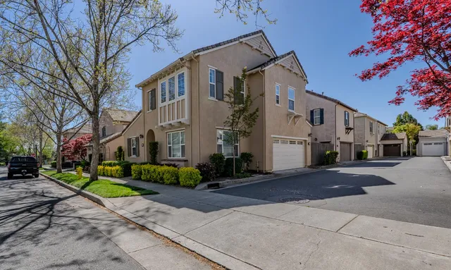 a front view of a house with a yard and a garage