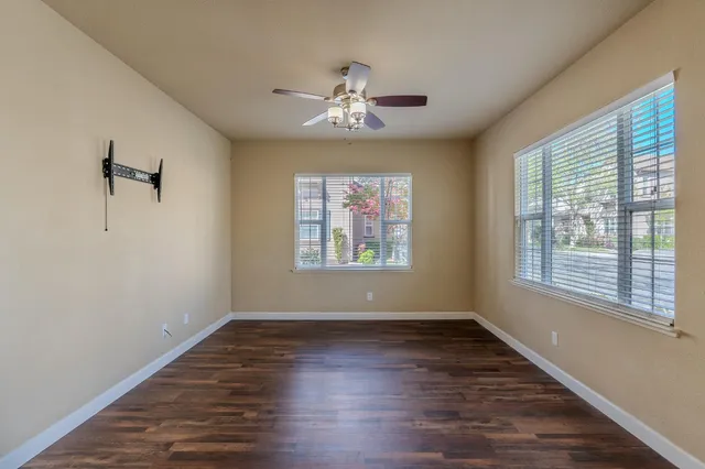 wooden floor in an empty room with a window