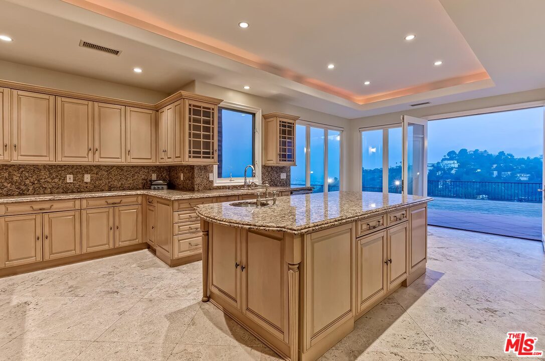 2121 Mt Olympus Drive Los Angeles, CA 90046 - Photo 17 of 34 a kitchen with sink stove and cabinets