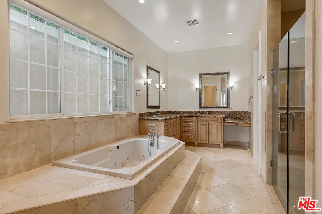 2121 Mt Olympus Drive Los Angeles, CA 90046 - Photo 24 of 34 a bathroom with a tub sink and mirror
