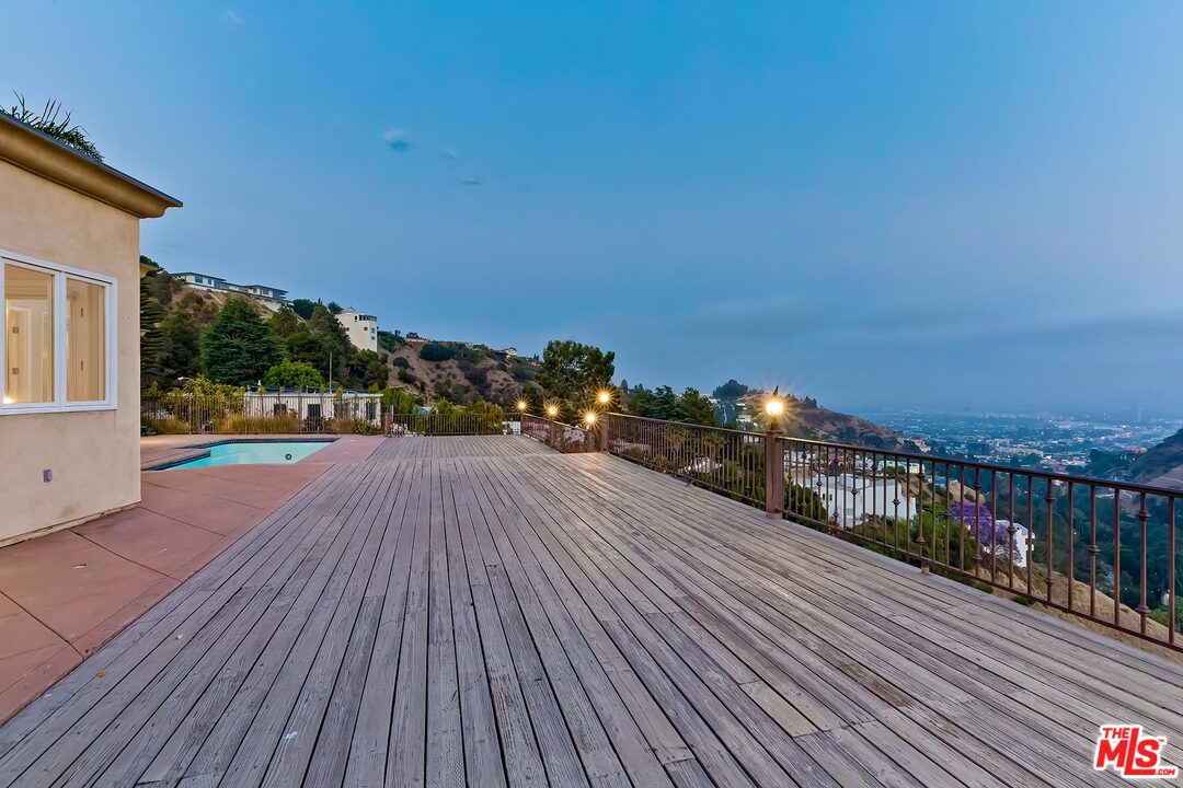 2121 Mt Olympus Drive Los Angeles, CA 90046 - Photo 32 of 34 a view of a balcony with wooden floor and city view