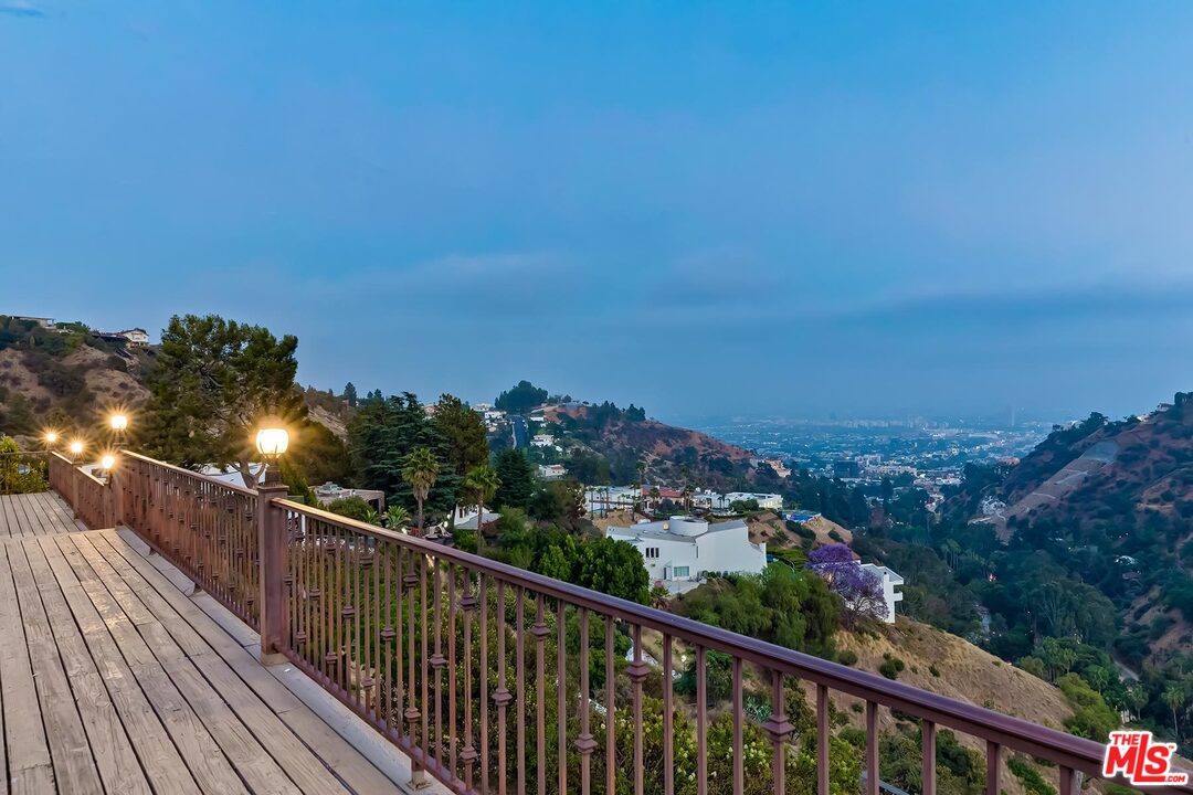 2121 Mt Olympus Drive Los Angeles, CA 90046 - Photo 34 of 34 a view of a balcony with wooden floor and city view
