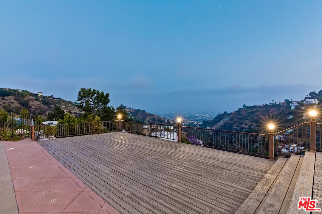 2121 Mt Olympus Drive Los Angeles, CA 90046 - Photo 5 of 34 a patio with table and chairs and potted plants