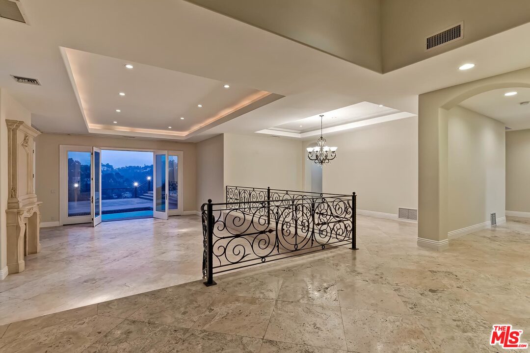 2121 Mt Olympus Drive Los Angeles, CA 90046 - Photo 8 of 34 a view of a hallway with wooden floor and stairs