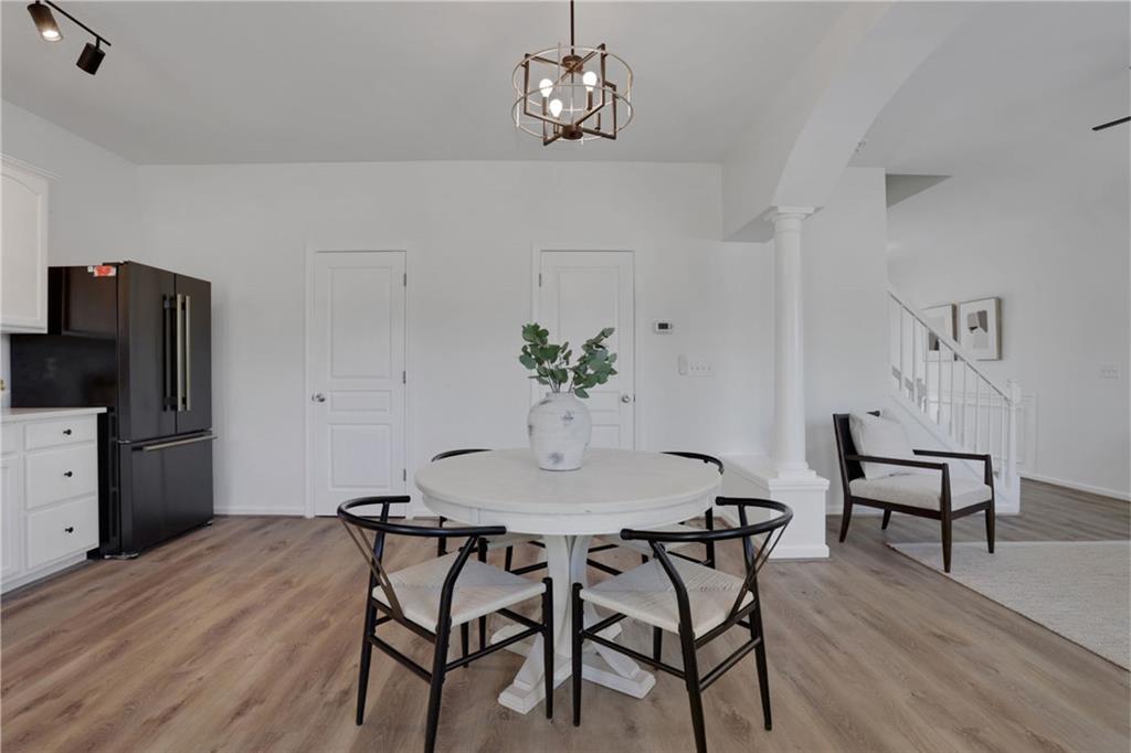 3552 Clear Creek Crossing Northwest Kennesaw, GA 30144 - Photo 11 of 41 a view of a dining room with furniture and wooden floor