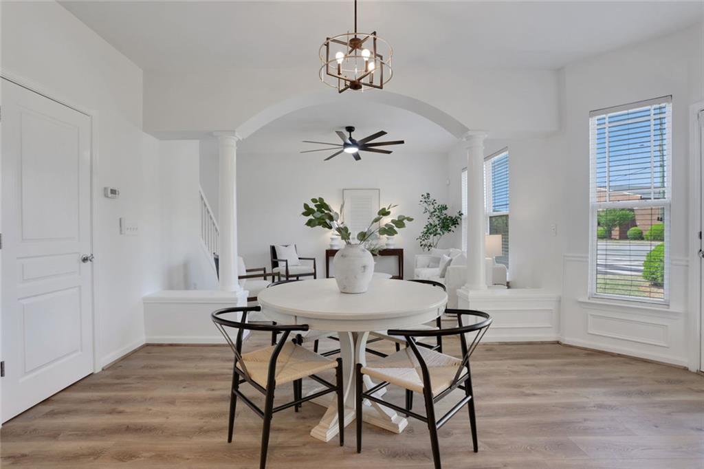 3552 Clear Creek Crossing Northwest Kennesaw, GA 30144 - Photo 12 of 41 a view of a dining room with furniture wooden floor and chandelier