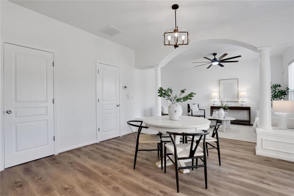 3552 Clear Creek Crossing Northwest Kennesaw, GA 30144 - Photo 17 of 41 a view of a dining room with furniture wooden floor and a chandelier