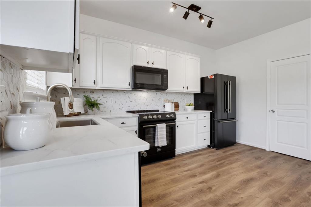 3552 Clear Creek Crossing Northwest Kennesaw, GA 30144 - Photo 18 of 41 a kitchen with stainless steel appliances a refrigerator stove and microwave