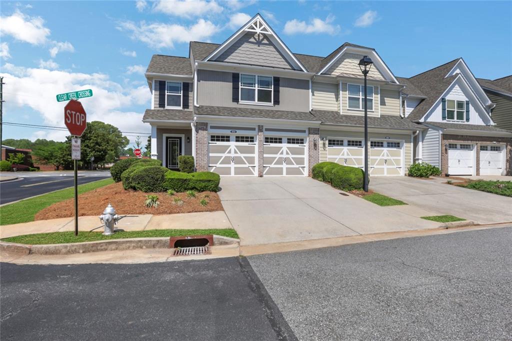3552 Clear Creek Crossing Northwest Kennesaw, GA 30144 - Photo 2 of 41 a front view of a house with a yard and garage