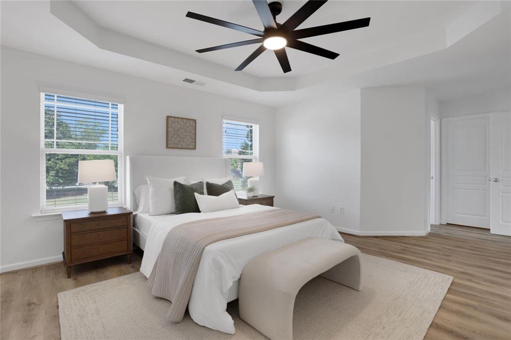 3552 Clear Creek Crossing Northwest Kennesaw, GA 30144 - Photo 24 of 41 a bedroom with a bed chandelier and a window