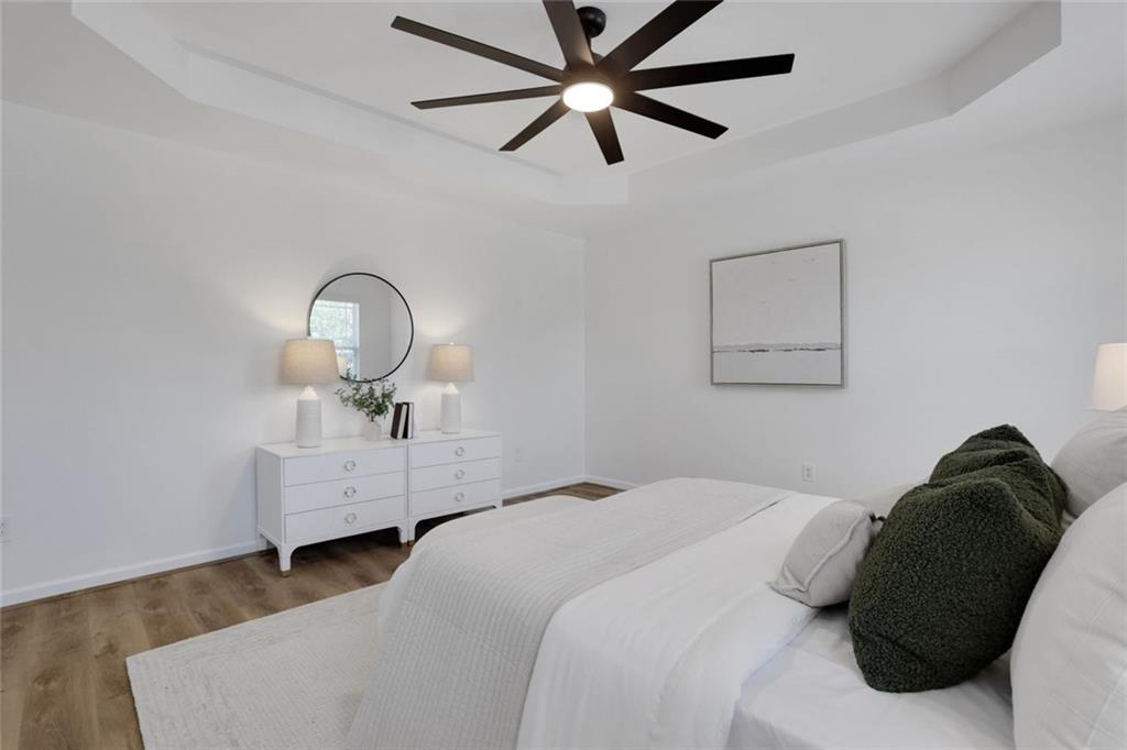 3552 Clear Creek Crossing Northwest Kennesaw, GA 30144 - Photo 26 of 41 a bedroom with a bed and a chandelier