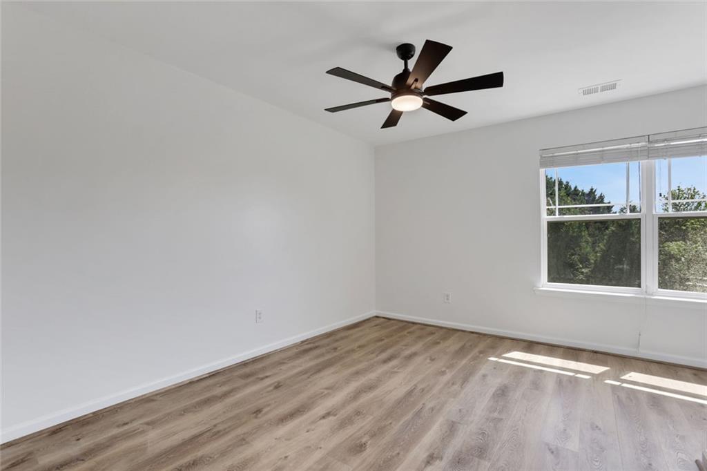 3552 Clear Creek Crossing Northwest Kennesaw, GA 30144 - Photo 34 of 41 a view of a big room with wooden floor and windows