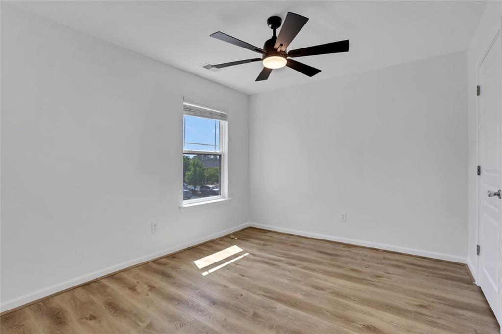 3552 Clear Creek Crossing Northwest Kennesaw, GA 30144 - Photo 36 of 41 a view of empty room with wooden floor and fan