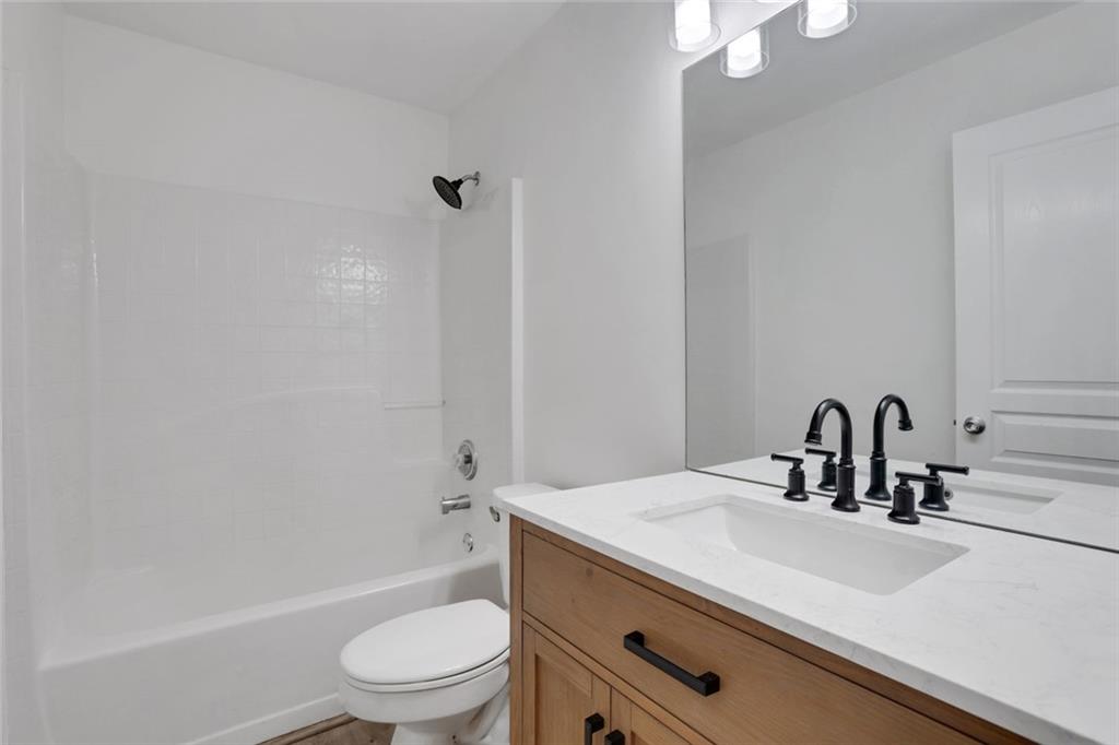 3552 Clear Creek Crossing Northwest Kennesaw, GA 30144 - Photo 38 of 41 a bathroom with a sink a toilet and shower