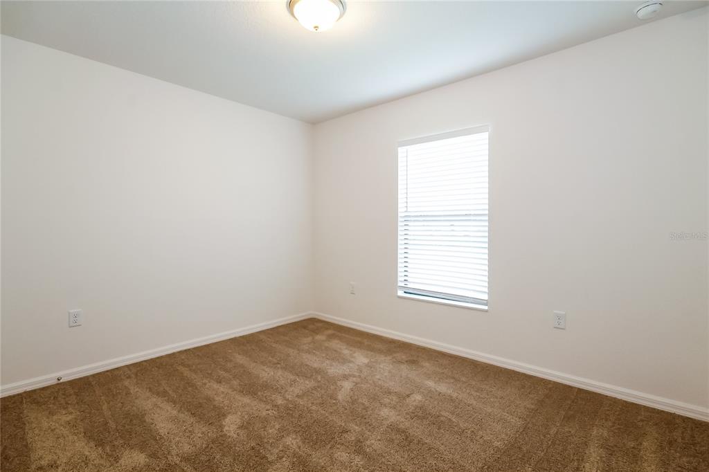 8615 Silverbell Loop Brooksville, FL 34613 - Photo 12 of 16 an empty room with a window