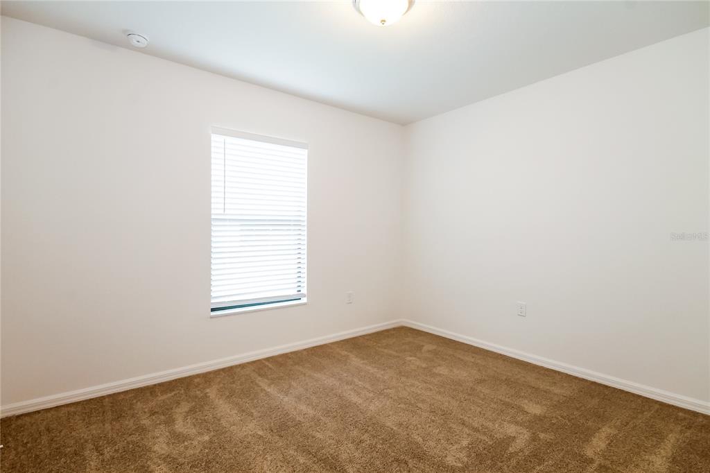 8615 Silverbell Loop Brooksville, FL 34613 - Photo 13 of 16 an empty room with a window