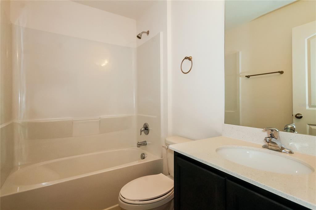 8615 Silverbell Loop Brooksville, FL 34613 - Photo 14 of 16 a bathroom with a sink a toilet and shower