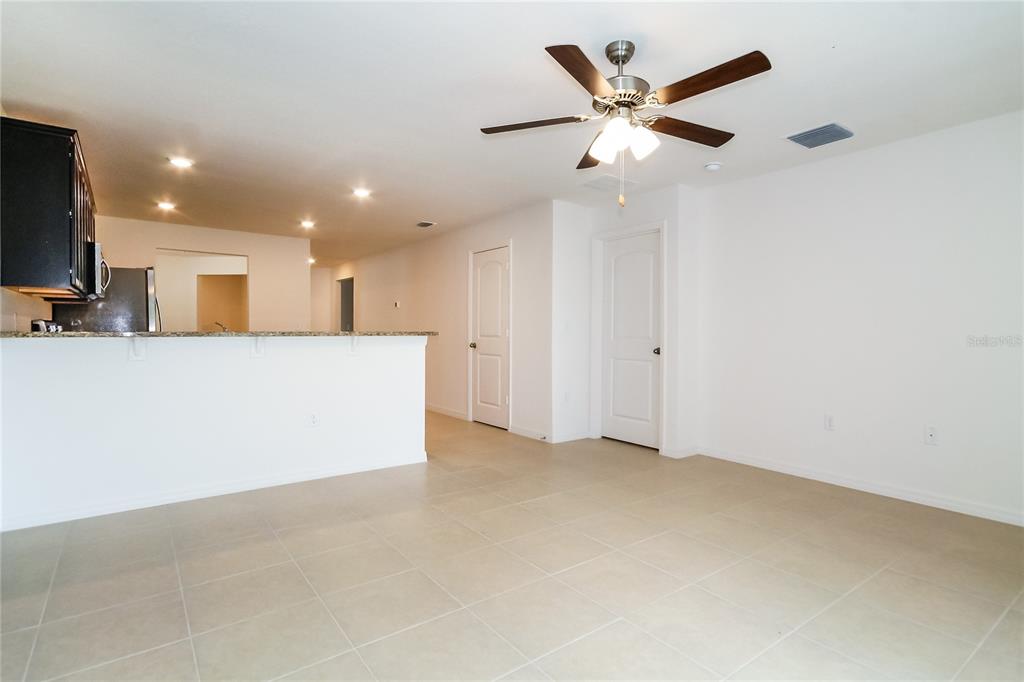 8615 Silverbell Loop Brooksville, FL 34613 - Photo 8 of 16 an empty room with cabinet and a ceiling fan