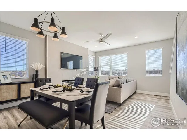 a living room with furniture a chandelier and a window