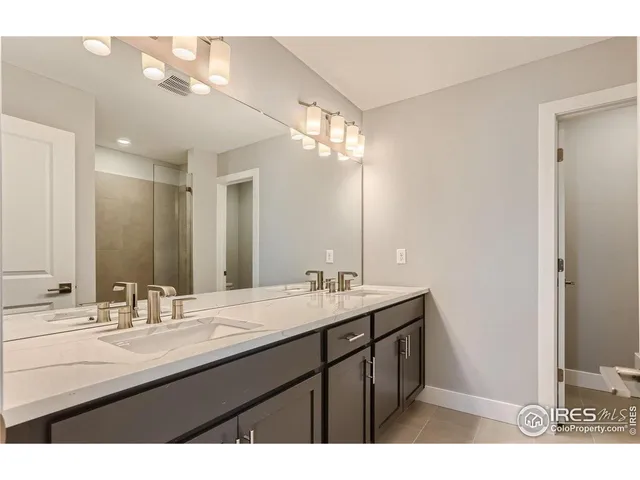 a bathroom with a double vanity sink mirror and double