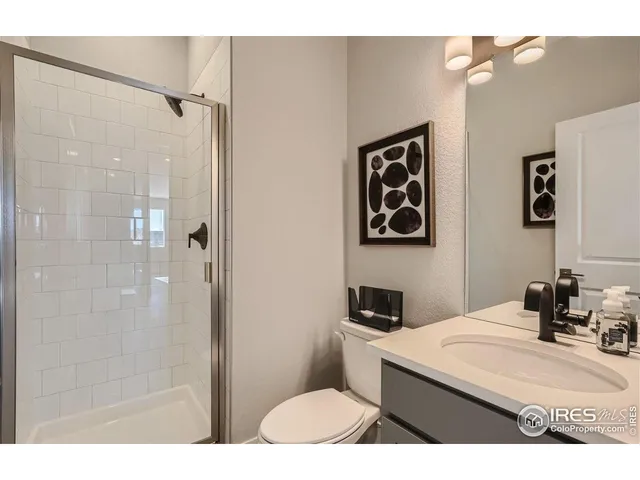 a bathroom with a sink toilet vanity and shower
